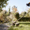 Gardener with weedwacker cutting grass garden